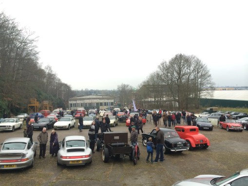 Porsches, Model T Ford hot rods and Riley 1.5 on the start finish straight at the 2015 Brooklands New Year's Day meeting